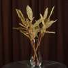 Искусственная веточка 63 см с ажурными блестящими листьями золотистая
